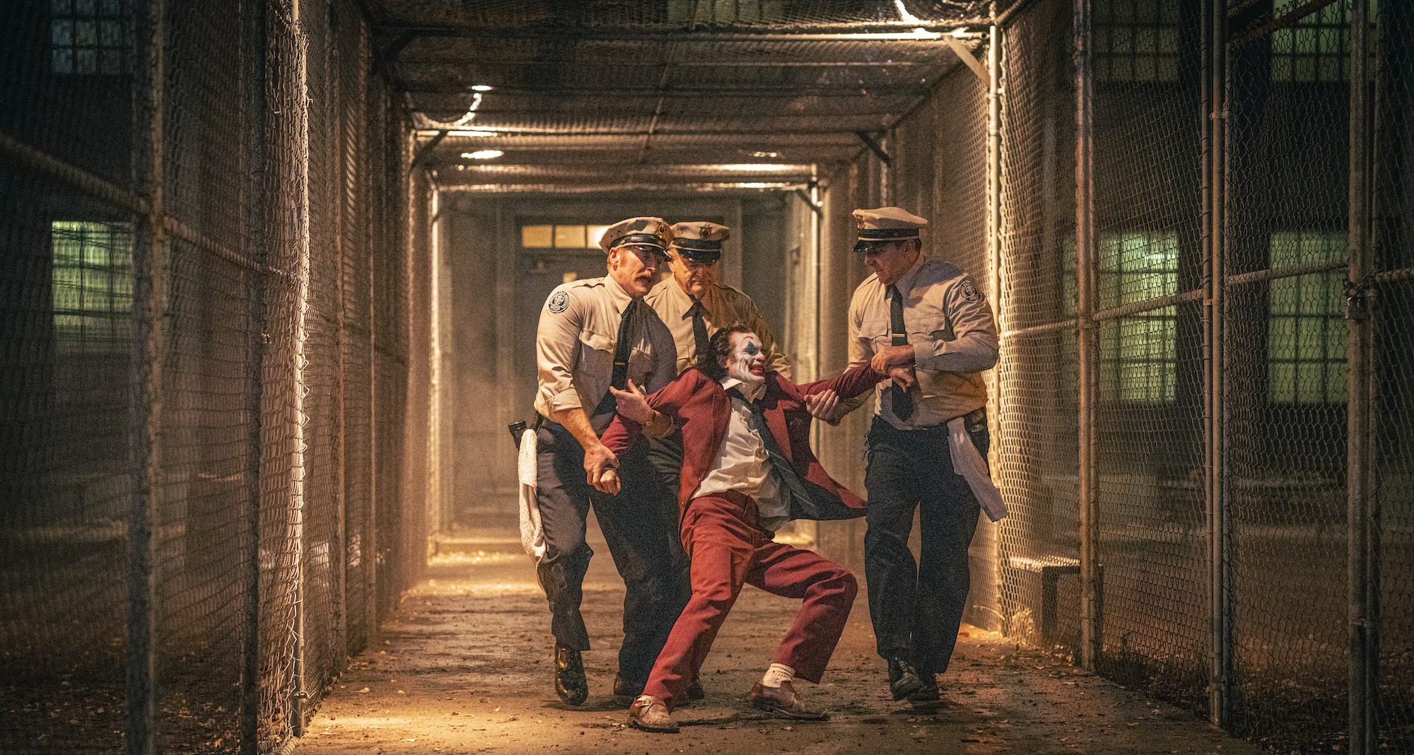 Brendan Gleeson as Jackie Sullivan and Joaquin Phoenix as Arthur Fleck/Joker in Joker: Folie à Deux